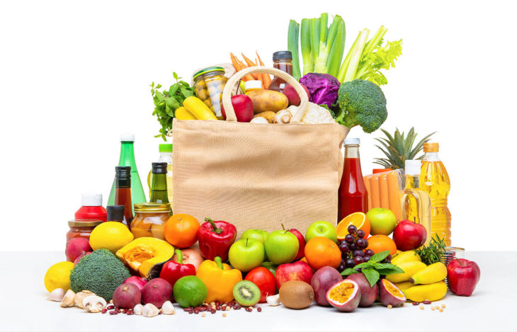 Shopping bag full of fresh fruits and vegetables with assorted i